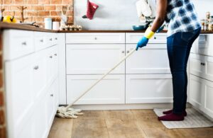 a person winter cleaning by mopping the floors