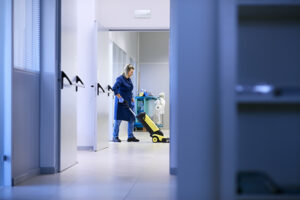 Cleaning employee tidying up medical office