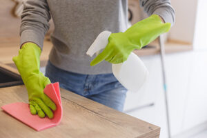 Image of woman disinfecting home after the flu